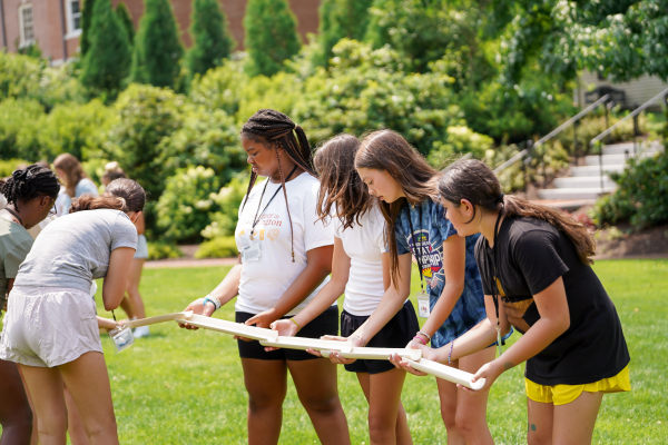 Girls working together on team building exercises at Summer in Farmington